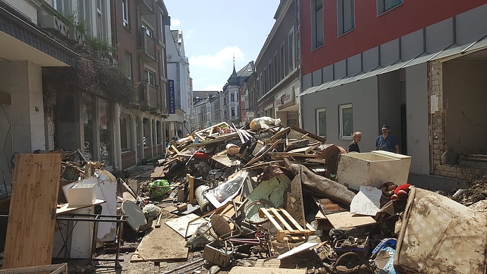 Verwüstungen nach der Flutkatastrophe in Stolberg, zerstörte Möbel und Schmutz türmen sich in einer Strasse